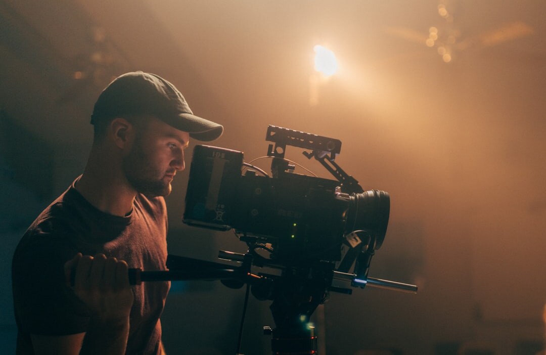 Camera operator filming an event with a professional camcorder