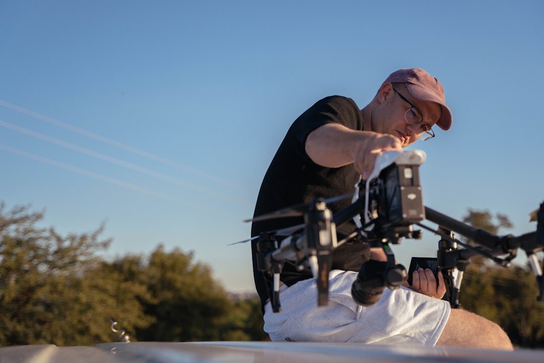 Technician preparing a camera drone for aerial broadcast